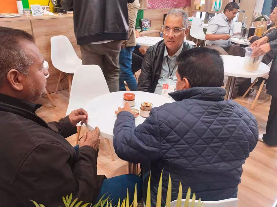 Artesanu Global engaging with international representatives during a trade fair to explore market opportunities and business connections.